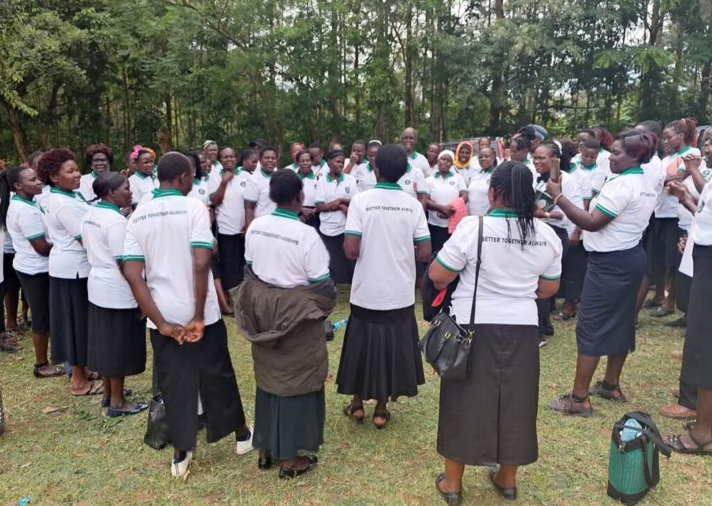 Group of Prosper members in white and green shirts standing together outdoors